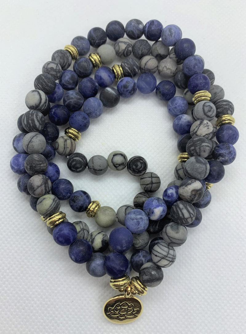 Natural Blue Picasso Marble Mala with golden Lotus looks modern with aesthetic appeal. You can wear it on your hand like a wrist mala/bracelet or around your neck.