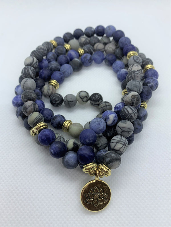 Natural Blue Picasso Marble Mala with golden Lotus looks modern with aesthetic appeal. You can wear it on your hand like a wrist mala/bracelet or around your neck.