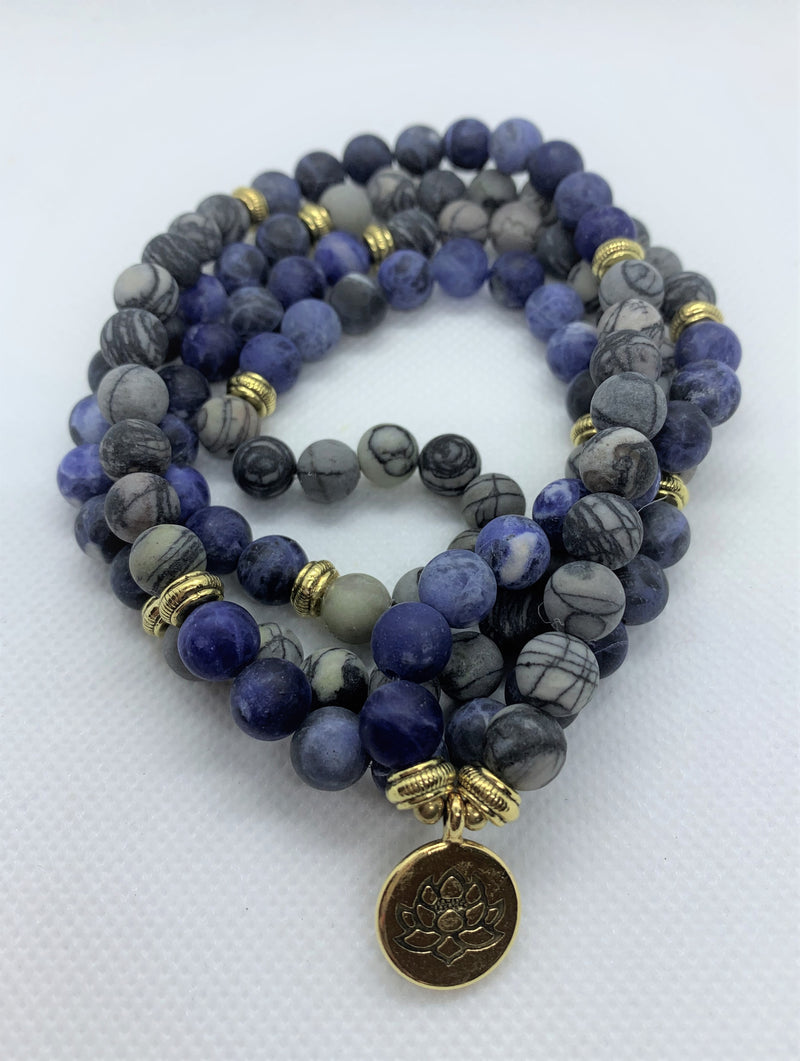 Natural Blue Picasso Marble Mala with golden Lotus looks modern with aesthetic appeal. You can wear it on your hand like a wrist mala/bracelet or around your neck.