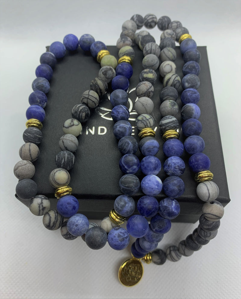 Natural Blue Picasso Marble Mala with golden Lotus looks modern with aesthetic appeal. You can wear it on your hand like a wrist mala/bracelet or around your neck.