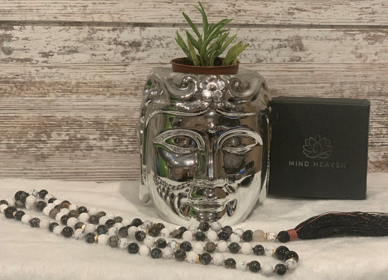 "Mynd-Intuition" beautiful and unique 108 hand-made mala necklace features gray opal and white turquoise with one round rose quartz as marker bead with black tassel and pink-colored knotted threads.