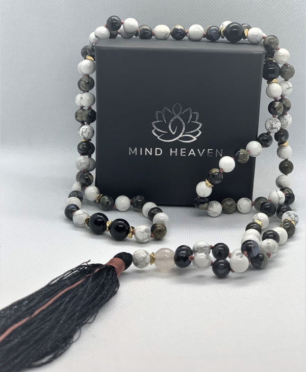 "Mynd-Intuition" beautiful and unique 108 hand-made mala necklace features gray opal and white turquoise with one round rose quartz as marker bead with black tassel and pink-colored knotted threads.