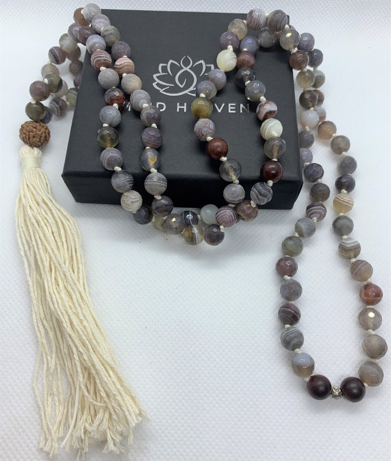 “Mynd-Light” This exclusive 108 hand-made mala beads necklace features Crazy Lace Agate beads with beige tassel and a Rudraksha as the Gury bead.   Malas are used to count the number of times a mantra is recited while meditating or praying. It comes with 108 beads, while you wear your mala throughout the day it serves as a constant reminder of your intentions and enhances your style. 