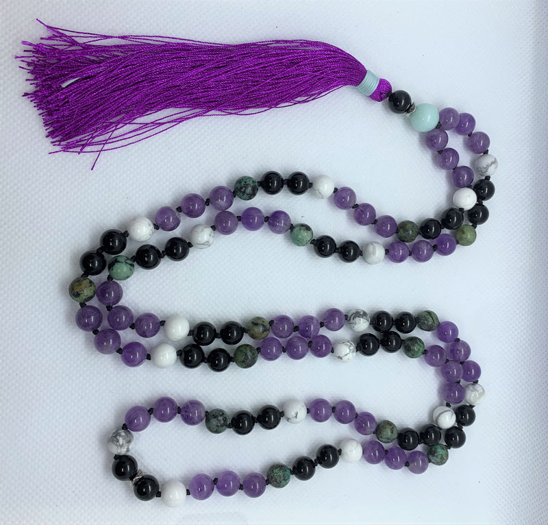 "Mynd-Happiness" is a Stunning and Colorful 108 hand-made mala necklace that features Amethyst and African Turquoise with purple Tassel.