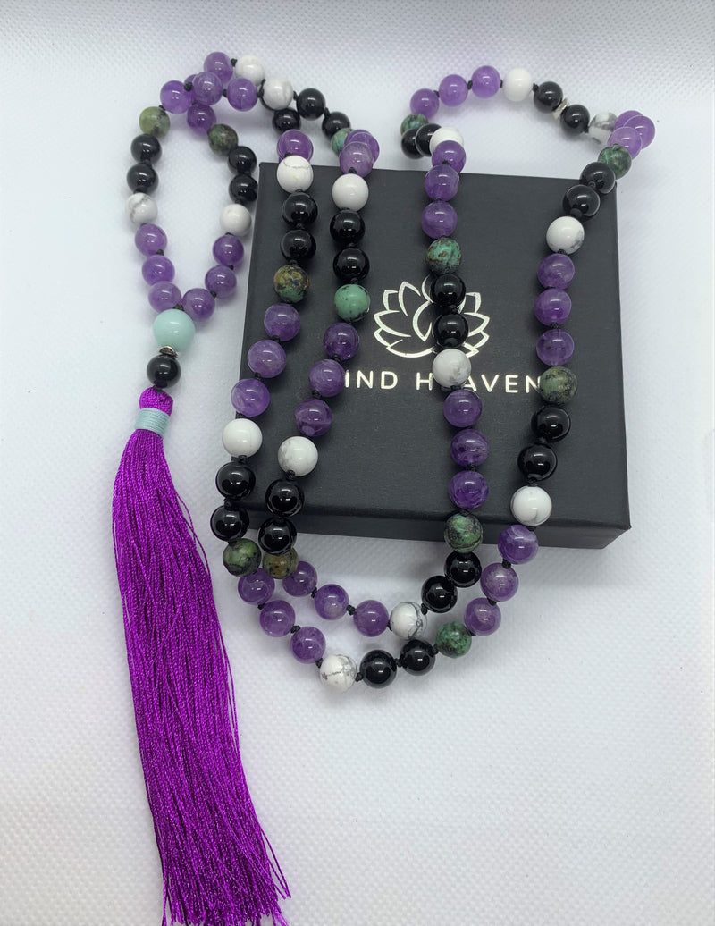 "Mynd-Happiness" is a Stunning and Colorful 108 hand-made mala necklace that features Amethyst and African Turquoise with purple Tassel.