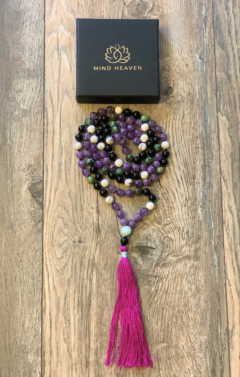"Mynd-Happiness" is a Stunning and Colorful 108 hand-made mala necklace that features Amethyst and African Turquoise with purple Tassel.