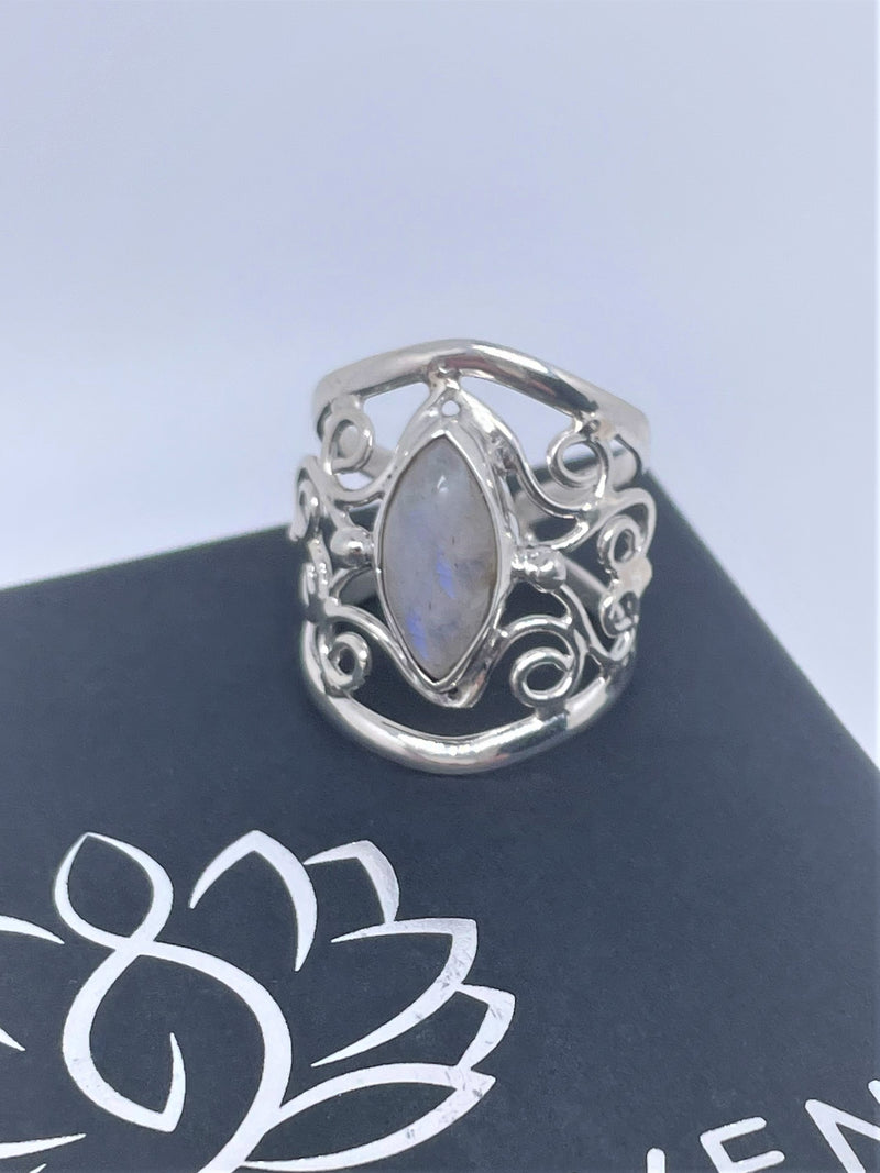 The mysterious glow of this oval moonstone cabochon is beautifully presented in this textured and polished sterling silver ring. It will make a gorgeous statement with any ensemble. 1" wide. Moonstone scrollwork ring.