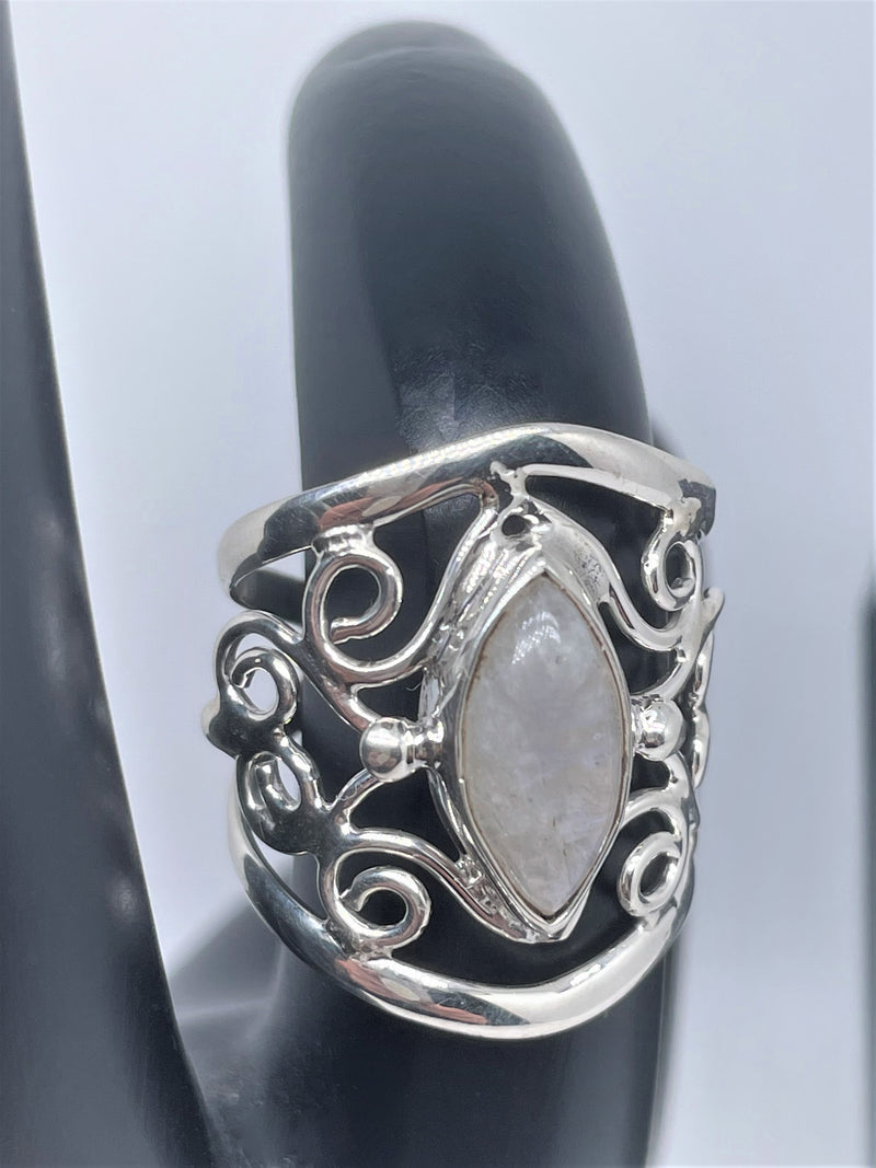 The mysterious glow of this oval moonstone cabochon is beautifully presented in this textured and polished sterling silver ring. It will make a gorgeous statement with any ensemble. 1" wide. Moonstone scrollwork ring.