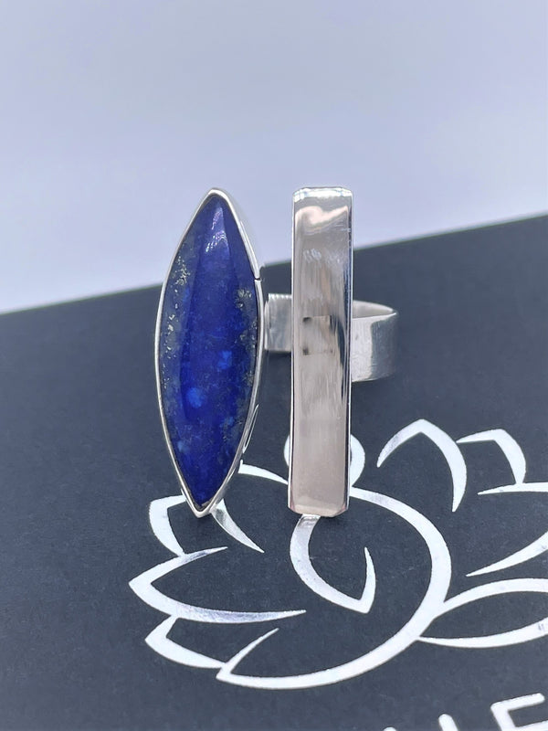 Bold, blue, and beautiful will definitely stand out, with its unique oval gemstone and silver line with sterling silver band. The oval lapis lazuli gemstone adds the perfect pop to any of your favorite looks. Pyrite flecks will vary. Two-tone