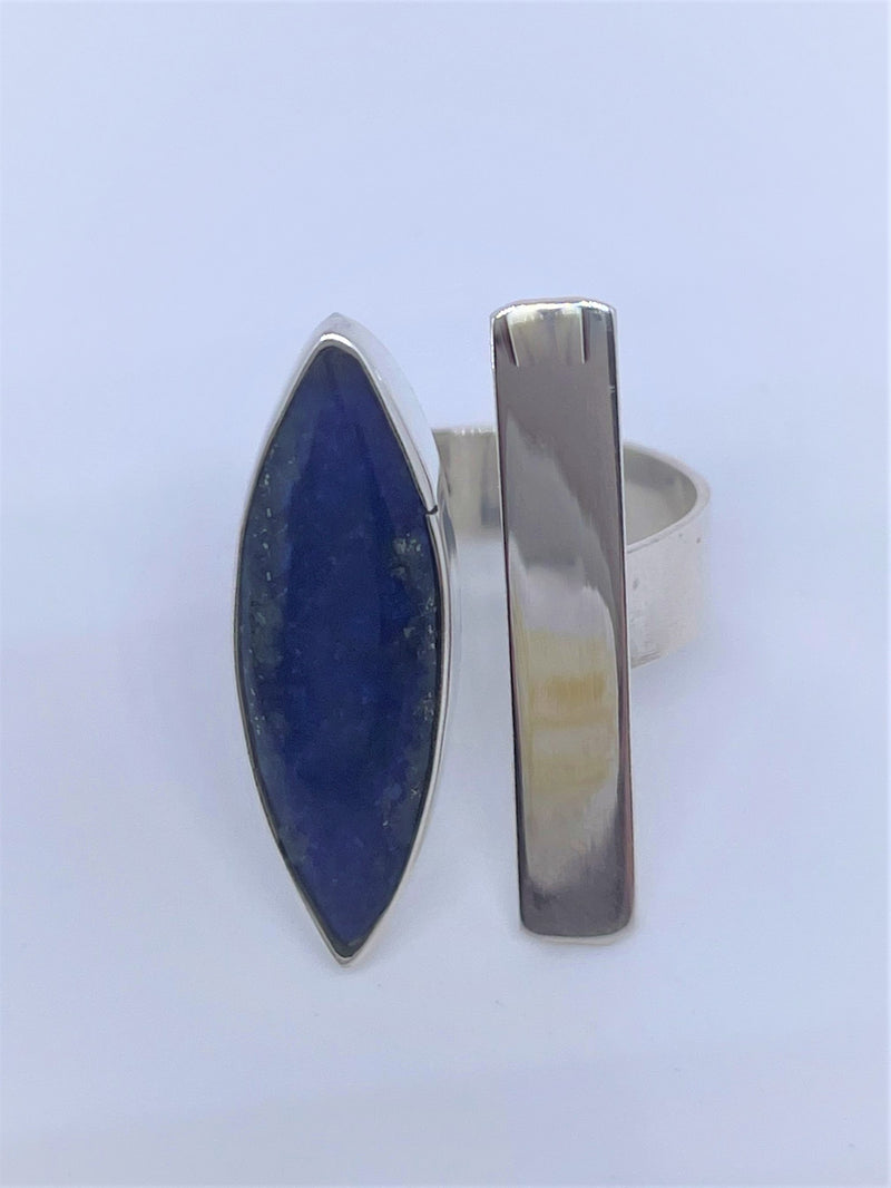 Bold, blue, and beautiful will definitely stand out, with its unique oval gemstone and silver line with sterling silver band. The oval lapis lazuli gemstone adds the perfect pop to any of your favorite looks. Pyrite flecks will vary. Two-tone