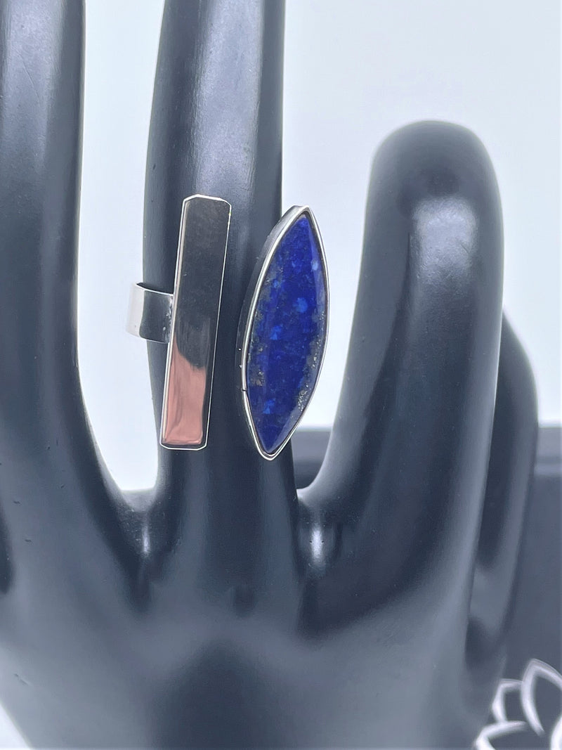 Bold, blue, and beautiful will definitely stand out, with its unique oval gemstone and silver line with sterling silver band. The oval lapis lazuli gemstone adds the perfect pop to any of your favorite looks. Pyrite flecks will vary. Two-tone