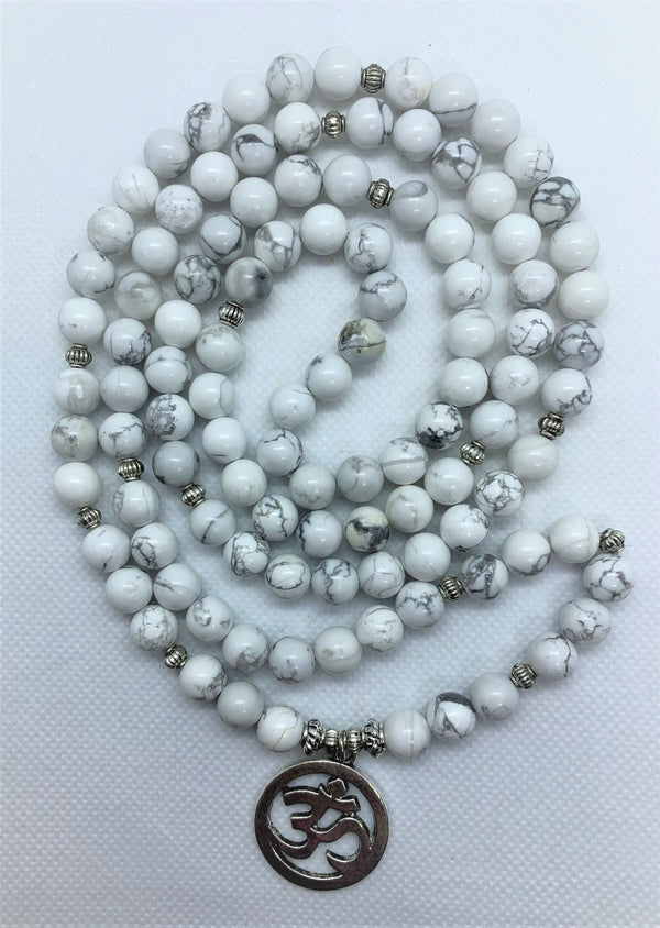 Howlite is often worn as a reminder of patience. The marbled stone is associated with inner calm, stress release, and soothing an overactive mind.   The Om symbol is the fundamental representation of the sound that originates from all living beings.