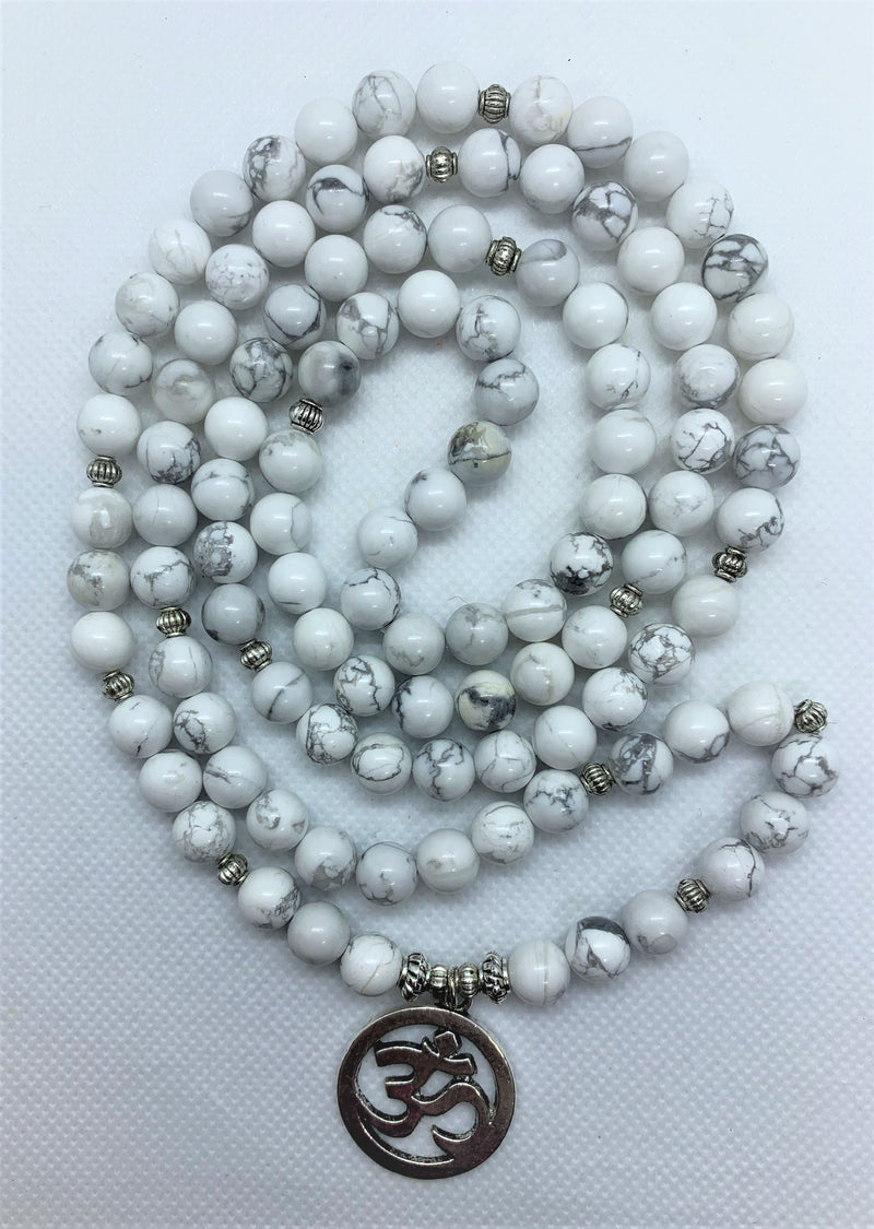 Howlite is often worn as a reminder of patience. The marbled stone is associated with inner calm, stress release, and soothing an overactive mind.   The Om symbol is the fundamental representation of the sound that originates from all living beings.
