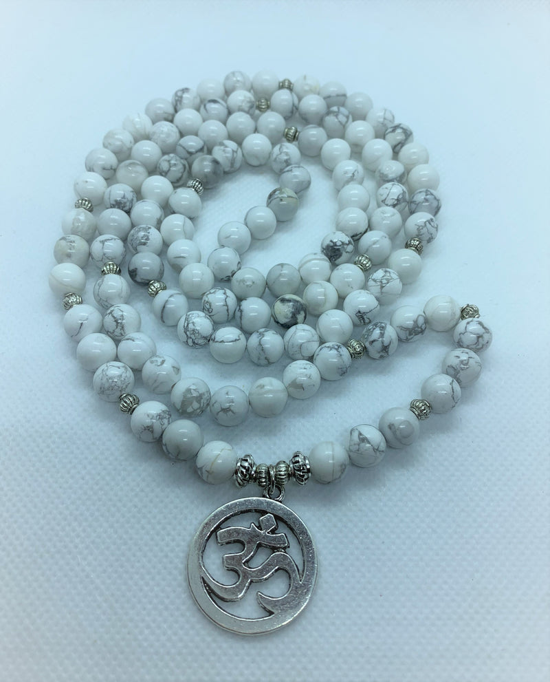 Howlite is often worn as a reminder of patience. The marbled stone is associated with inner calm, stress release, and soothing an overactive mind.   The Om symbol is the fundamental representation of the sound that originates from all living beings.