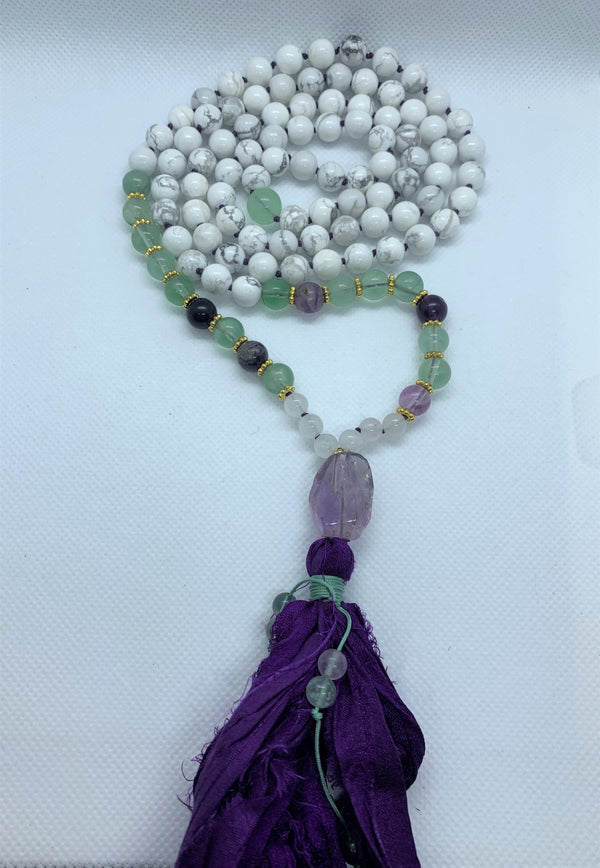  "Mynd-Energy" is a unique 108 hand-made necklace that features Amethyst and White Turquoise with fabric tassel and Amethyst Guru bead. Necklace multicolor