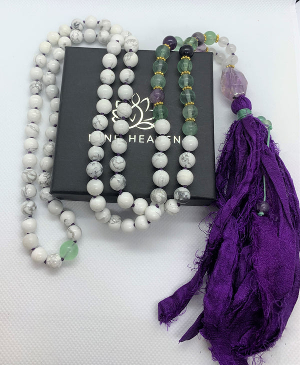 "Mynd-Energy" is a unique 108 hand-made necklace that features Amethyst and White Turquoise with fabric tassel and Amethyst Guru bead. Necklace multicolor