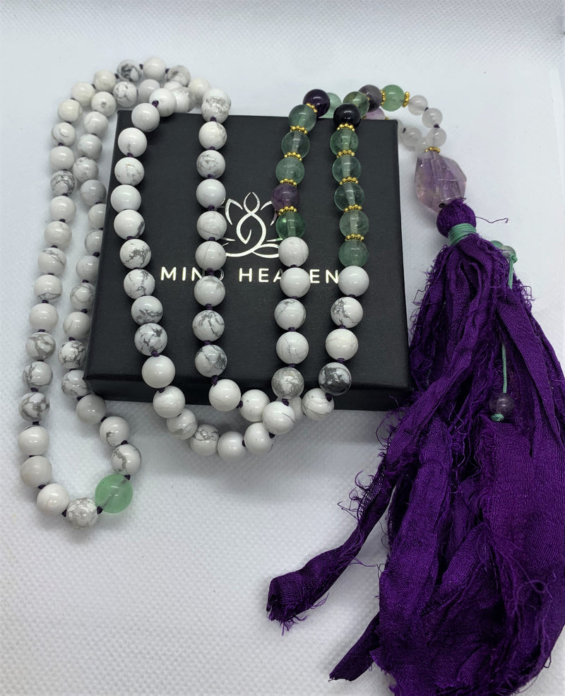 "Mynd-Energy" is a unique 108 hand-made necklace that features Amethyst and White Turquoise with fabric tassel and Amethyst Guru bead. Necklace multicolor