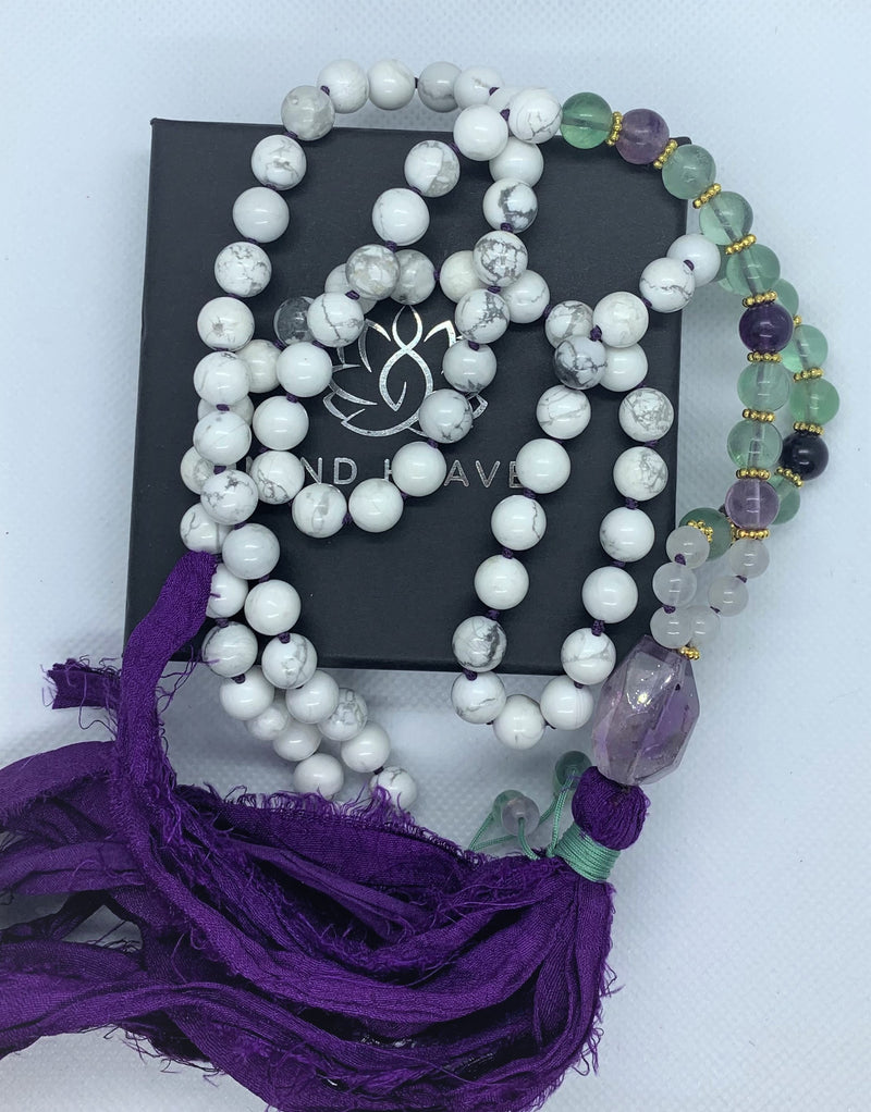 "Mynd-Energy" is a unique 108 hand-made necklace that features Amethyst and White Turquoise with fabric tassel and Amethyst Guru bead. Necklace multicolor