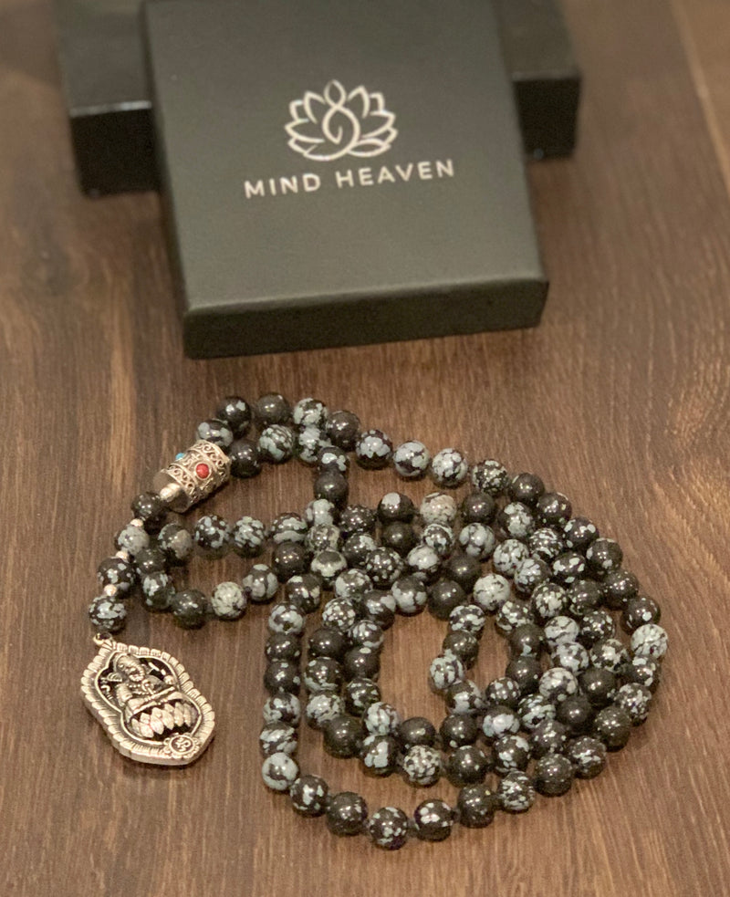 "Mynd-Success" This Stunning and elegant 108 hand-made mala necklace features snowflake obsidian with Ganesha pendant