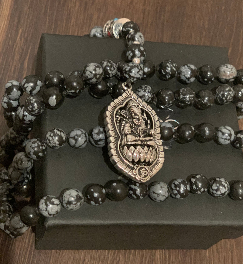 "Mynd-Success" This Stunning and elegant 108 hand-made mala necklace features snowflake obsidian with Ganesha pendant