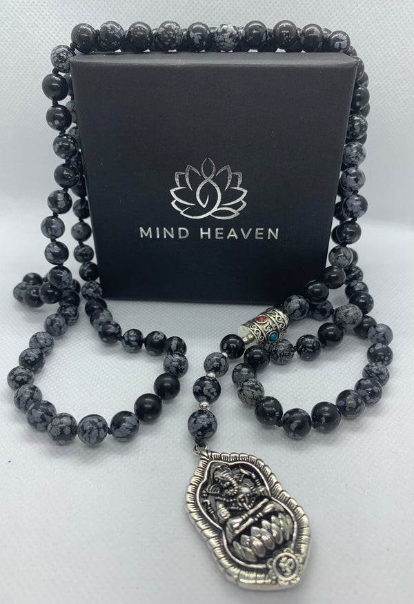 "Mynd-Success" This Stunning and elegant 108 hand-made mala necklace features snowflake obsidian with Ganesha pendant