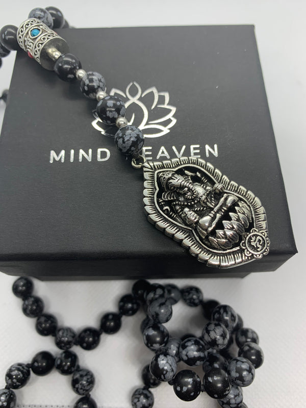 "Mynd-Success" This Stunning and elegant 108 hand-made mala necklace features snowflake obsidian with Ganesha pendant